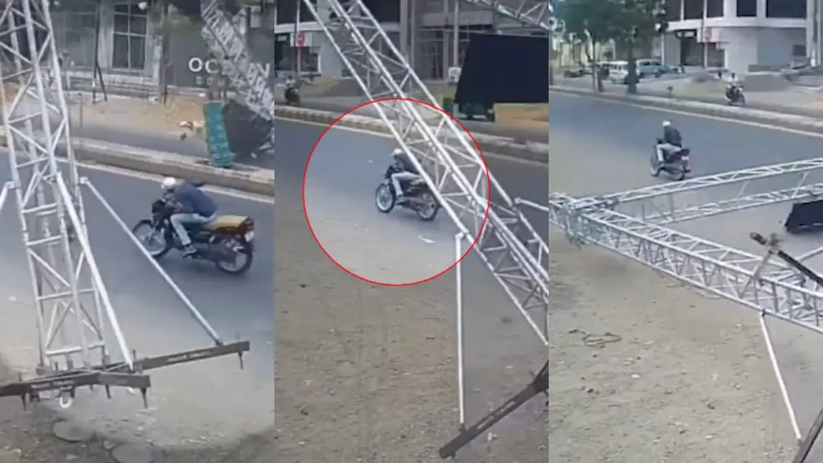 jamnagar-news-led-hoarding-gate-collapes-on-road-bike-rider-safe-caught-in-cctv-footage